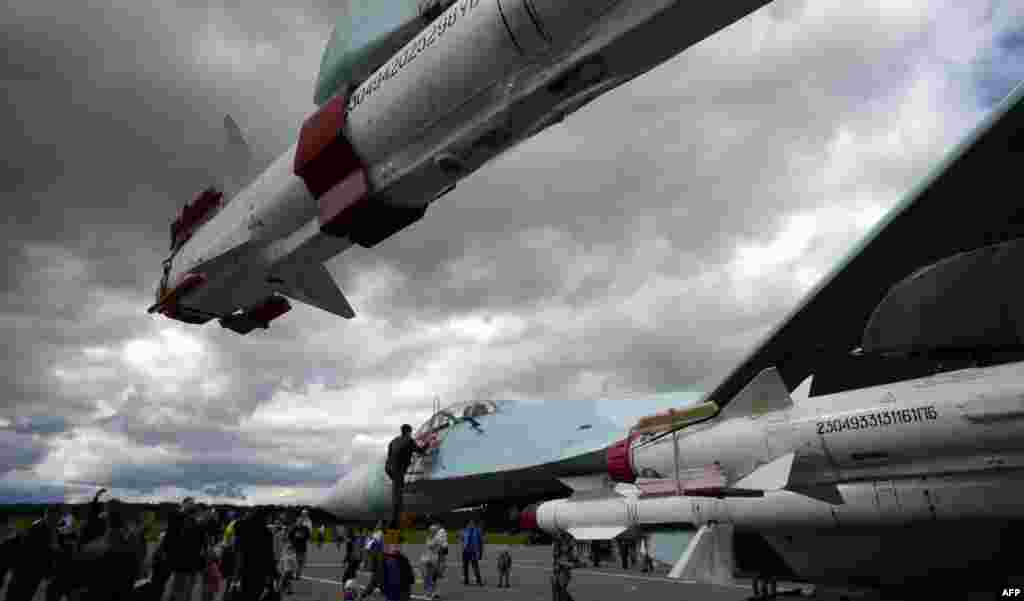 Members of the public visit Su-27 jet fighters during celebrations for Russian Air Force Day in Pushkin, outside of St. Petersburg, on August 12. (AFP/Olga Maltseva)