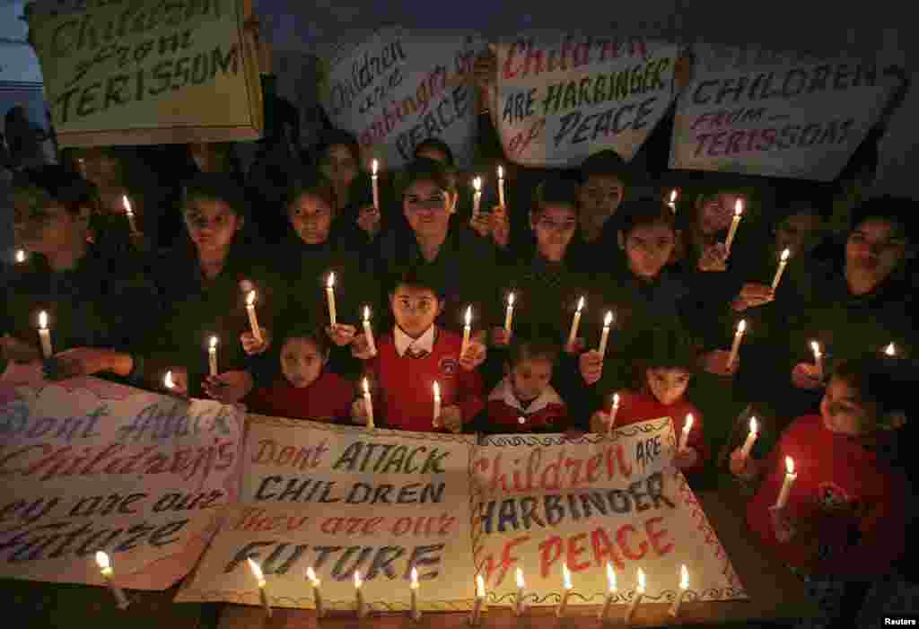 Indian schoolchildren hold candles in the northern city of Amritsar on December 17 as they pray for the victims of a Taliban attack on a school in Peshawar, Pakistan. At least 141 people, mainly students, died in the attack.
