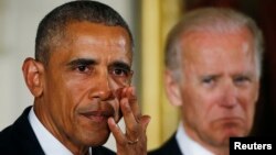 A Russian political scientist has claimed that U.S. President Barack Obama (left) will hand over the reins of power to his Vice President Joe Biden (right) this year and that the latter will rule the country in a "tandem" agreement similar to the one that allowed Vladimir Putin to continue pulling the strings after he completed his first spell as Russian president in 2008. 