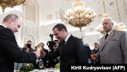  Наздравица сред Владимир Путин и премиера Дмитрий Медведев пред Сергей Суровикин, след гала за връчване на държавни награди на военнослужещи в Сирия - Кремъл, 2017 година 