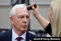 Czech presidential candidate Jiri Drahos has makeup applied ahead of a debate in Prague on December 12.