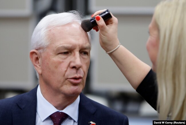 Czech presidential candidate Jiri Drahos has makeup applied ahead of a debate in Prague on December 12.