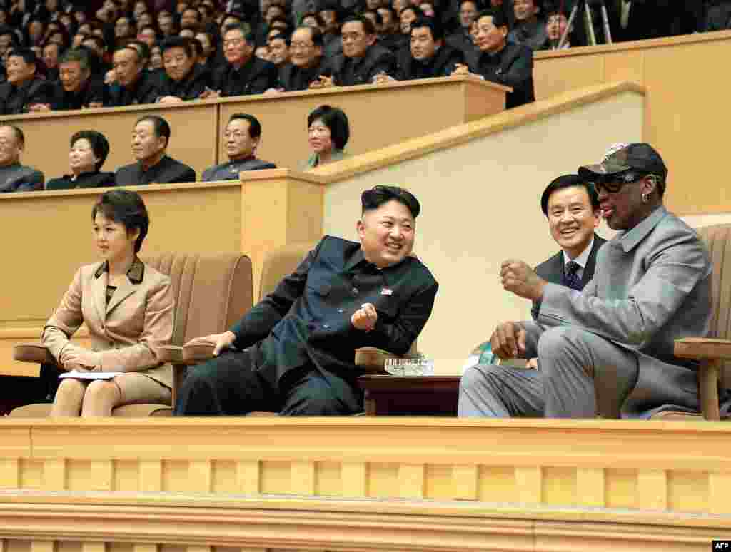 A photo released by North Korea&#39;s official Korean Central News Agency shows Kim Jong Un (center), his wife Ri Sol Ju (left) and former NBA star Dennis Rodman (right) watching a basketball game between former NBA players and North Korean players in Pyongyang.