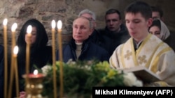 Images of Russian President Vladimir Putin (center) attending mass on Orthodox Christmas morning seemed aimed at sending a message that contrasted this placid setting with the violence and chaos at the U.S. Capitol.