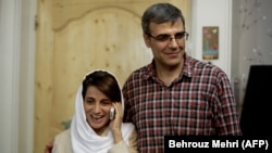 Lawyer Nasrin Sotoudeh speaks on the phone alongside her husband, Reza Khandan, at their house in Tehran in 2013.