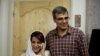 IRAN -- Lawyer Nasrin Sotoudeh (L) speaks on the phone next to her husband Reza Khandan as they pose for a photo at their house in Tehran, September 18, 2013