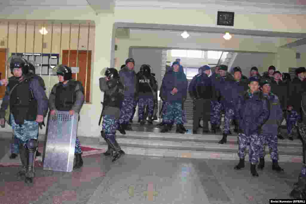 Heavily armed police wait inside City Hall.&nbsp;