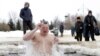 A Russian Orthodox believer takes a dip in icy water during celebrations of Epiphany in Moscow. People believe that plunging themselves into blessed waters during Epiphany strengthens their spirit and body. (epa/Maxim Shipenkov)