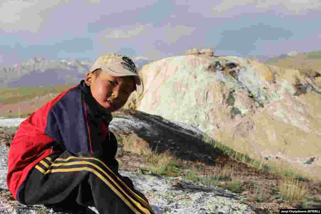 A boy sits in front of the Bakpur-Ata shrine at some 5,000 meters in altitude.