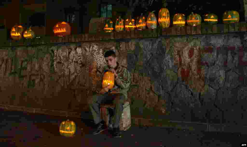 A boy sells carved Halloween pumpkins in Tirana, Albania. (AFP/Gent Shkullaku)