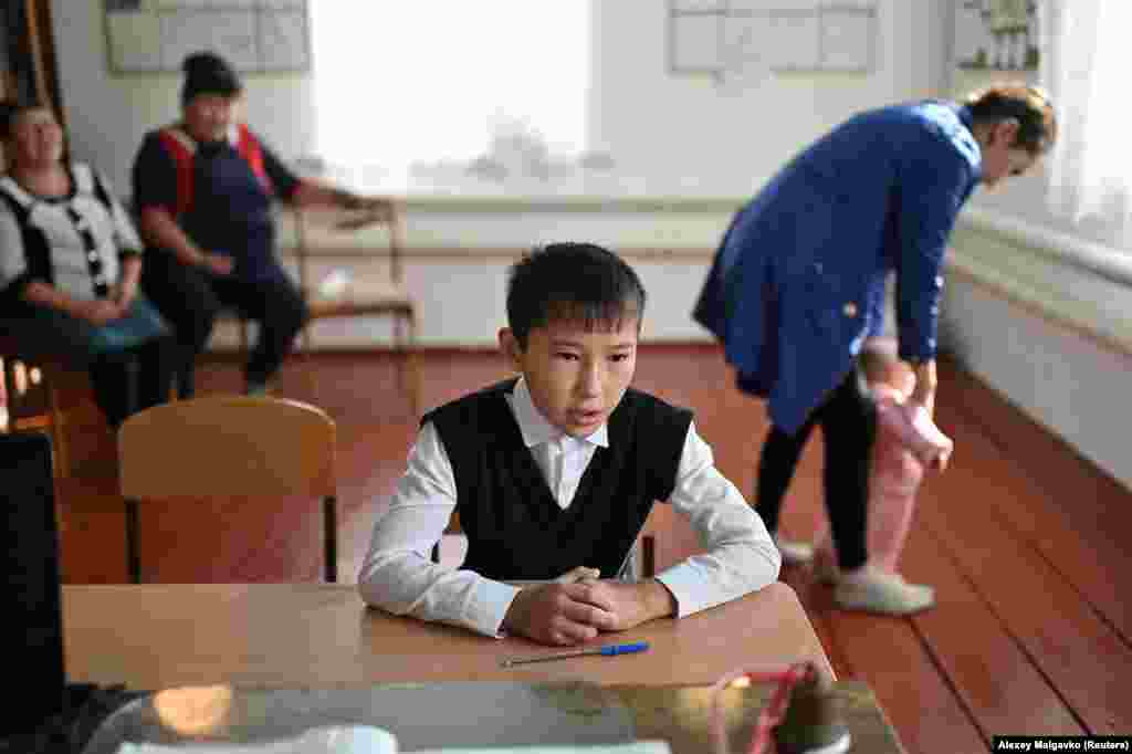 Izhmukhametov during a lesson as relatives look on. Kuchukova hopes Izhmukhametov will soon feel confident enough to travel to a neighboring village for lessons.