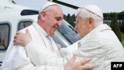  На тази фотоси от 2013 година папа Бенедикт е с бели облекла, до момента в който посреща наследника на поста си папа Франциск. 