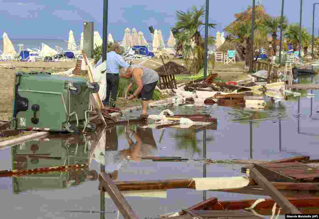 GREECE - Two men search in debris after a storm at Nea Plagia village in Halkidiki region, northern Greece on Thursday, July 11, 2019