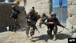 Afghan soldiers take up positions during a patrol in the Batikot district in September 17.