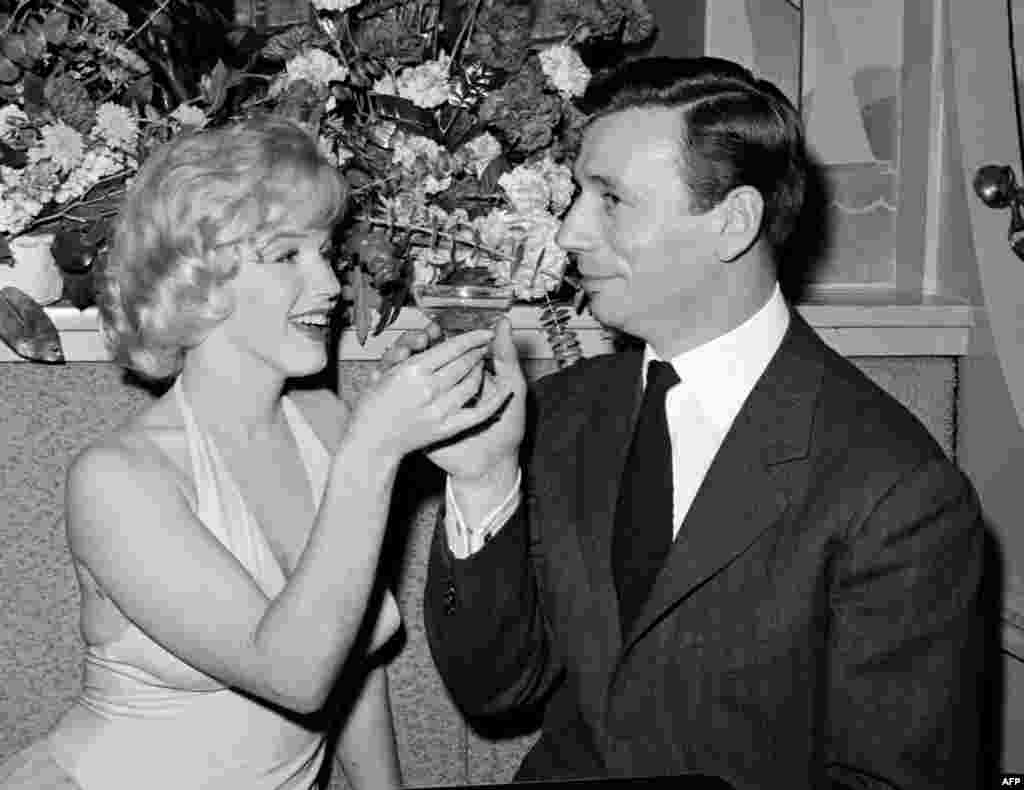 Monroe shares a glass of champagne with French actor and singer Yves Montand in Hollywood after the screening of their movie &quot;Let&#39;s Make Love,&quot; directed by George Cukor, in 1960.