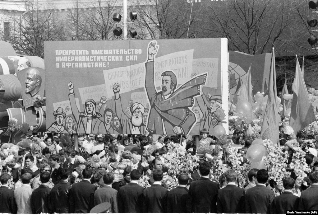 May Day marchers on Red Square carry a placard demanding "an end to imperialistic meddling in Afghanistan" on May 1, 1980.