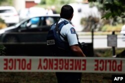 A policeman stands guard Masjid al-Noor mosque after a deadly shooting incident in Christchurch, New Zealand, on March 15.