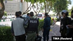 Iranian police stand near the parliament building during an attack by gunmen in central Tehran on June 7.