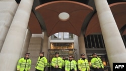 Police stand guard outside the London Stock Exchange in central London,