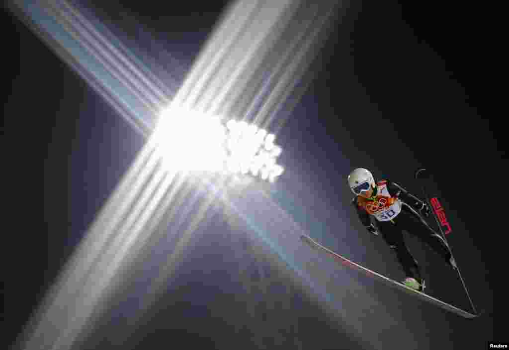 Japan's Sara Takanashi soars through the air during her trial jump in the women's ski jumping individual normal hill event.