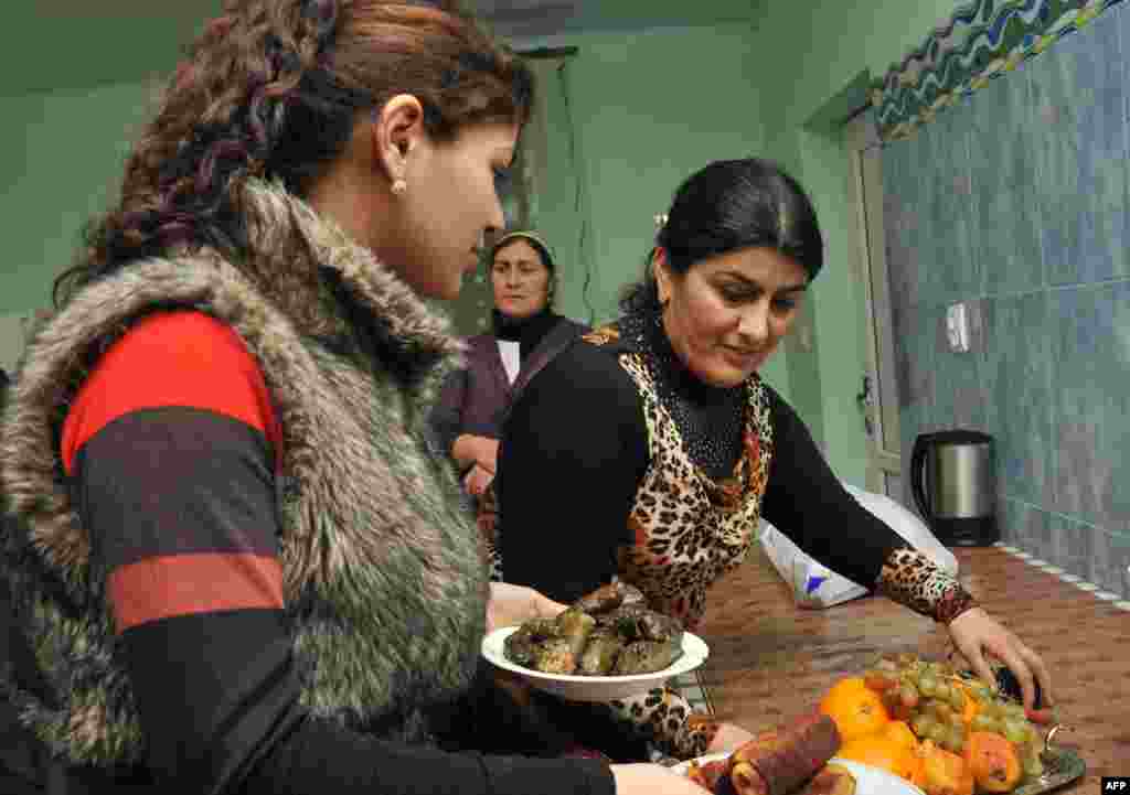 Armenia -- Women of Yezidi community put the dinner on at their home in the Armenian village of Zovuny, 01May2013