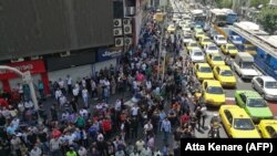 Iranian protesters shout slogans during a demonstration in central Tehran, June 25, 2018