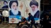 Shiite Muslim pilgrims in Iraq walk in front of posters of (R to L) Iran's Supreme Leader Ayatollah Ali Khamenei, the spiritual leader of the Shiite community Grand Ayatollah Ali Sistani, and the leader of Lebanon's Hezbollah movement Hasan Nasrallah. October 12, 2019. 