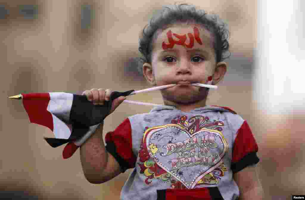 A girl with the colors of the Egyptian flag and the word "leave" painted on her face is seen during a demonstration against Egyptian President Muhammad Morsi in front of the presidential palace in Cairo. (Reuters/Amr Abdallah Dalsh)