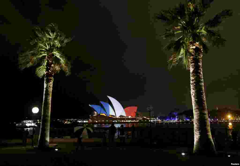 The blue, white, and red colors of France's national flag are projected onto the sails of Sydney's Opera House in Australia as a show of solidarity with the people of France following the November 13 terrorist attacks in Paris. (Reuters/Jason Reed)