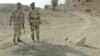 Pakistani paramilitary soldiers guard the site of a landmine blast planted by alleged Baluch nationalists in the Dera Bugti region in 2006.