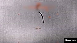 A still image from surveillance video provided by the U.S. military shows what they say is a drone being shot down over the Strait of Hormuz, June 20, 2019. U.S. Department of Defense/Handout via REUTERS. ATTENTION EDITORS - THIS IMAGE WAS PROVIDED BY A THIRD PARTY.
