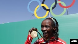 Kenyan gold-medalist Jemima Jelagat Sumgong poses after the podium ceremony for the women's marathon at the Rio 2016 Olympic Games at Sambodromo in Rio de Janeiro on August 14.