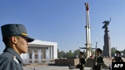 Kyrgyzstan -- Honor guards march near a national flag standing at half -mast in Bishkek, 07Oct2008