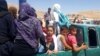 Syrian refugees arrive in Wadi Hamayyed, on the outskirts of Lebanon's northeastern border town of Arsal, to board buses bound for the northwestern Syrian town of Idlib last month.