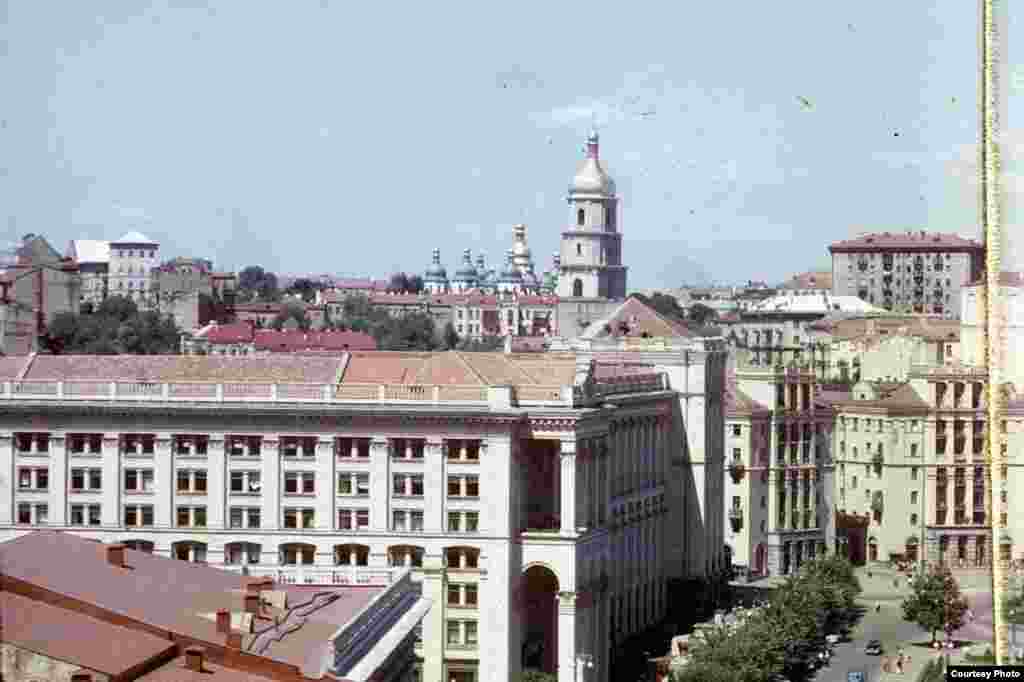 In this photograph of Kyiv, one can see where central Khreshchatyk Street runs through Independence Square. The large building on the corner is the Main Post Office, with St. Sophia&#39;s Cathedral and its belfry in the background.