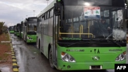 Buses that were meant to evacuate civilians from rebel-held areas of Aleppo are seen waiting on December 14.