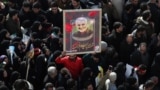 IRAN -- A portrait of slain Iranian Revolutionary Guards Corps (IRGC) Lieutenant general and commander of the Quds Force Qasem Soleimani is paraded as thousands of mourners gather to pay tribute for his funeral in Tehran, Iran, 06 January 2020. 