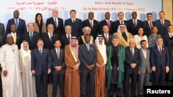 President Muhammad Morsi stands with other leaders of Islamic nations for a group photo before the opening of the Organization of Islamic Cooperation summit in Cairo.