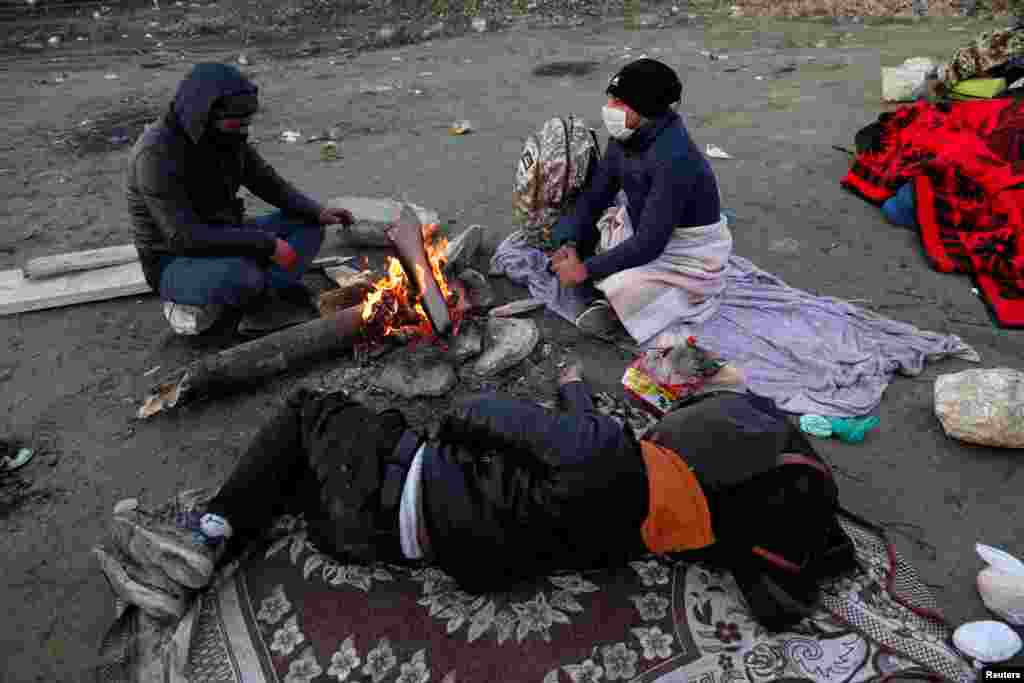 Migrants from Pakistan sit on a roadside near Turkey&#39;s Ipsala border crossing with Greece on March 2. In 2016, the&nbsp;European Union pledge to provide 6 billion euros in aid to Turkey to house refugees and migrants.&nbsp;The EU said it expected Turkey to &quot;uphold&quot; its side of the deal following the &quot;dangerous&quot; military escalation in Syria.