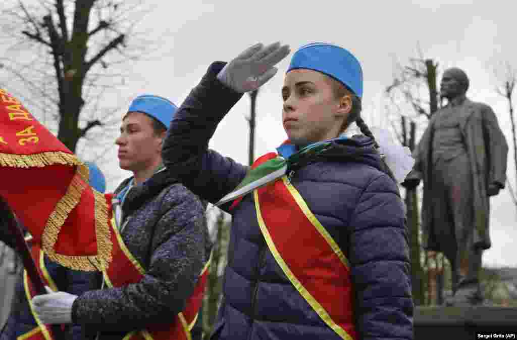 Members of the Belarusian Pioneers youth organization salute while standing in front of a monument to Soviet founder Vladimir Lenin during a ceremony marking the 100th anniversary of the 1917 Bolshevik Revolution, in Minsk. (AP/Sergei Grits)