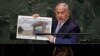 Israel's Prime Minister Benjamin Netanyahu shows an atomic warehouse in Teheran during his address the 73rd session of the United Nations General Assembly, at U.N. headquarters, Thursday, Sept. 27, 2018. (AP Photo/Richard Drew)