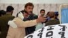 A paramedic staffer comforts a relative after a police officer and three of his family members were shot dead in Quetta.