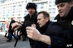 Kremlin critic Aleksei Navalny is detained during an anticorruption rally in central Moscow on March 26.