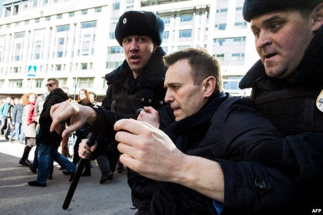 Kremlin critic Aleksei Navalny is detained during an anticorruption rally in central Moscow on March 26.