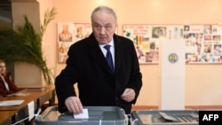 Moldovan President Radu Timofti casts his ballot in the presidential election at a polling station in Chisinau on October 30.