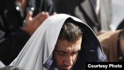 A man praying in a mosque in Tajikistan. 