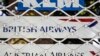 A picture taken on August 24, 2018 shows the logos of air line companies (top to bottom) Dutch KLM, British Airways, and Austrian Airlines, on the shuttered window of the closed offices of a travel agency in the Iranian capital Tehran. Air France and Brit