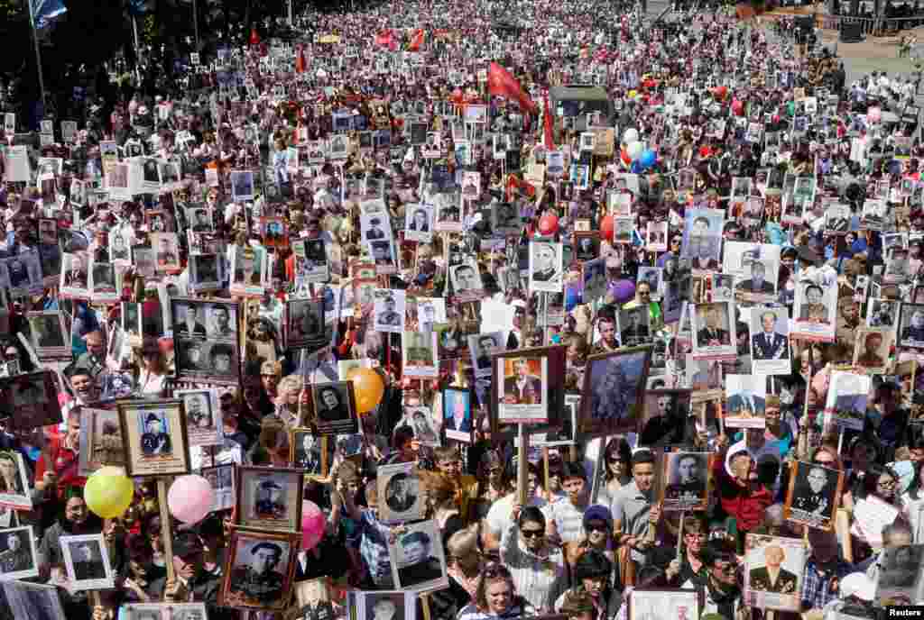 People carrying portraits of deceased relatives who took part in World War II march in a parade during Victory Day commemorations in Almaty, Kazakhstan, on May 9. (Reuters/Shamil Zhumatov)