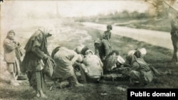 Armenian refugees eat the carcass of a horse in Hauran, Syria.