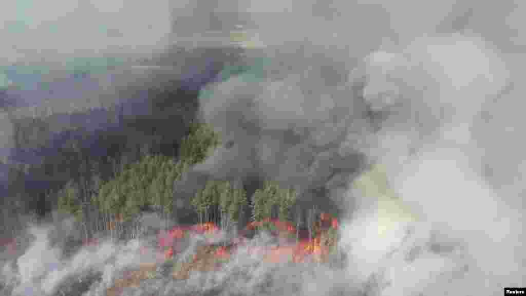 An aerial view shows a forest fire in the exclusion zone around the Chernobyl nuclear power plant on April 12. Ukraine&#39;s National Police said they had detained two people suspected of setting the initial fire.